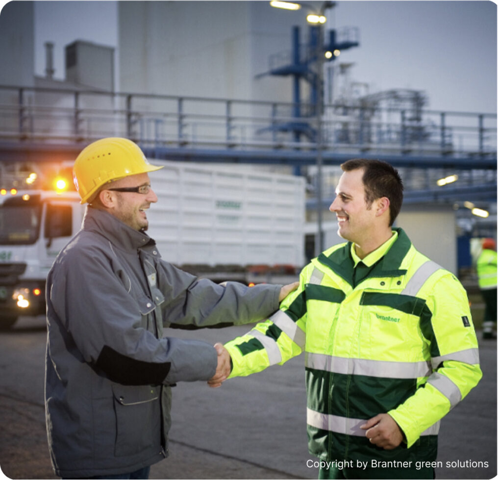 Two men standing and shaking hands at Brantner green solutions facilities